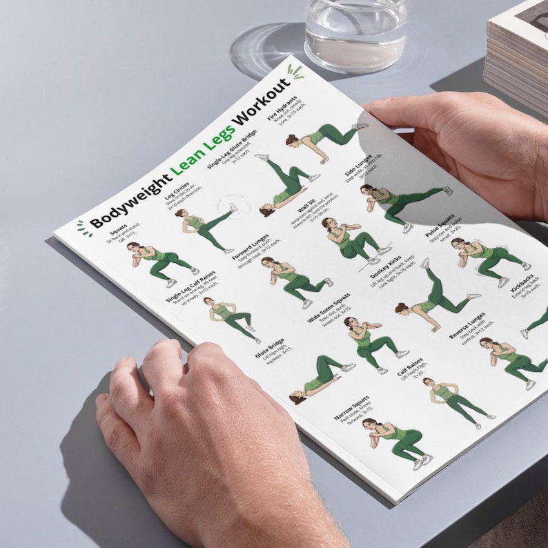 May include: A white printed workout sheet titled "Bodyweight Lean Legs Workout" with illustrations of exercises. The sheet is held by hands and features exercises like leg circles, glute bridge, and fire hydrants. The exercises are illustrated with green figures.