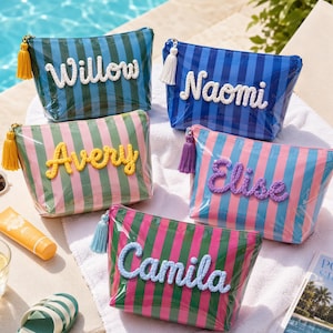 May include: Five rectangular cosmetic pouches with vertical stripes in various colour combinations. Each pouch features a personalised name in raised white, yellow, purple, or light blue rope lettering and a matching tassel on the zipper pull.