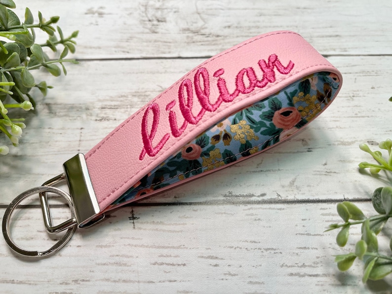 wristlet keychain with custom name. Made with vinyl and fabric inside. Many colors to choose from. Now offering gold hardware