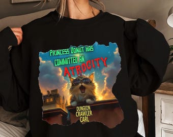 Dungeon Crawler Carl PNG, Princesa Donut PNG, Mongo PNG, Moda Geek, Merchandising de Libros