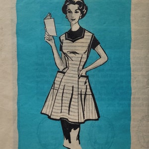 May include: Vintage sewing pattern for a dress with a large pocket on the front. The pattern is printed on a blue background and features a woman wearing the dress. The pattern number is 9331 and the size is Large.
