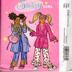 May include: A sewing pattern for a girl's robe and pyjamas. The pattern is called "Sassy Girl" and is for sizes 7-8, 10-12. The pattern includes a pink robe with a ruffled trim and a pair of pyjamas with a lipstick print.