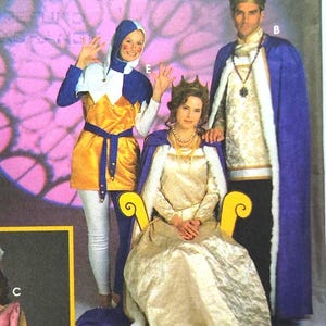May include: Simplicity Costumes sewing pattern featuring medieval and renaissance themed costumes. The pattern includes designs for a king, queen, and other characters. The costumes are shown in various colors, including gold, blue, and pink.