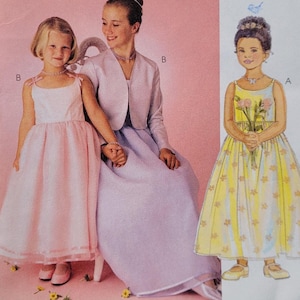 May include: McCall's sewing pattern with images of three girls in formal dresses. The cover displays a pink dress, a lavender dress with a jacket, and a yellow dress with floral details. The text on the cover reads "Special Moments".