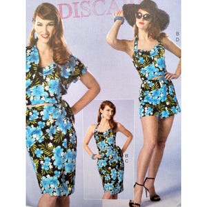 May include: A vintage sewing pattern showing three two-piece outfits. The designs include a skirt and top set, a halter top and skirt set, and a halter top and shorts set. All outfits have a black background with blue floral print.