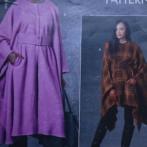 May include: A Vogue pattern featuring two women modeling different outerwear designs. One woman wears a purple coat with a belt, while the other models a brown plaid cape. The pattern includes sizes from 16 to 22.