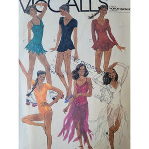 May include: A McCall's sewing pattern envelope featuring illustrations of six different leotard and skirt outfits. The designs include various sleeve lengths, necklines, and skirt styles in colours such as teal, black, red, orange, pink, and white.