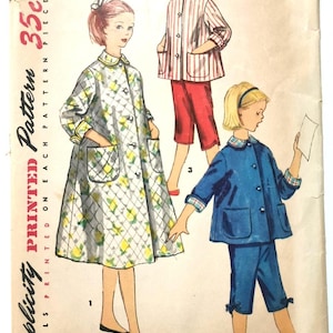 May include: Vintage Simplicity sewing pattern 1441, size 8, for a girl's dress and two different styles of pajamas. The pattern is printed on a single sheet of paper and includes instructions for making the garments.