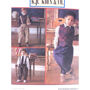 May include: A vintage sewing pattern by K.P. Kids & Co. featuring three boys in school-themed outfits. The outfits include suspenders, vests, ties, and dress pants. The boys are posed in front of a chalkboard and globe.