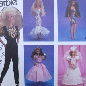 May include: A sheet featuring multiple Barbie doll images. The dolls are dressed in various outfits, including a leopard print top with black pants, a silver gown with a fishtail skirt, and a pink dress. The sheet has the word "Barbie" printed on it.