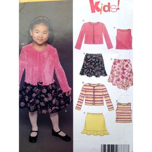 May include: A young girl wearing a pink velvet jacket and a black skirt with a floral pattern. The image also shows a sewing pattern with various children's clothing designs, including skirts, jackets, and tops. The word "Kids!" is in the upper right corner.