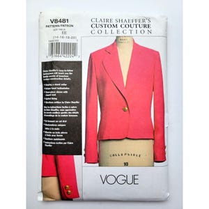 May include: A Vogue sewing pattern envelope for V8481, Claire Shaeffer's Custom Couture Collection. The front displays a bright pink blazer with a single gold button on a dress form, alongside text detailing instructions for a stand collar and sleeve vents.