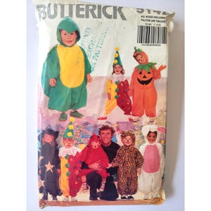 May include: A vintage Butterick pattern envelope featuring children's Halloween costumes. The costumes include a turtle, clown, pumpkin, star, and leopard print. The envelope is slightly worn and includes the text "Butterick".