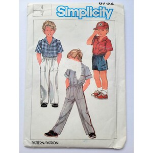 May include: A Simplicity sewing pattern envelope, number 8732, size 4. The front features illustrations of three outfits: a blue gingham shirt with white pants, a red shirt with blue shorts and a cap, and a gray jumpsuit with red side stripes.