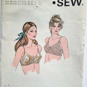 May include: Vintage Kwik Sew sewing pattern 1018 featuring illustrations of two bras. The pattern includes size and cup size information. The Kwik Sew logo is displayed in black. The pattern is designed by Kerstin Martensson.