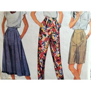 May include: A vintage sewing pattern featuring illustrations of women's clothing. The designs include a long blue skirt, red patterned pants, and tan shorts. The pattern is for Miss Petite sizes.