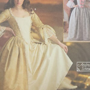 May include: A vintage sewing pattern for historical costumes. The image features a woman in a cream-colored gown with gold accents and lace trim. A second costume is shown in the background. The pattern is for adults.