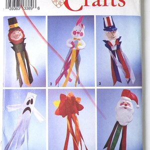May include: Simplicity Crafts pattern with six craft designs: a leprechaun, bunny, Uncle Sam, ghost, flower, and Santa Claus. Each design has colourful ribbon streamers. The pattern is one size.