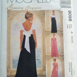 Pode incluir: Um padrão de costura McCall's para vestidos de noite. O padrão apresenta uma mulher em um vestido branco e preto com um detalhe de laço. Imagens adicionais mostram vestidos rosa e preto. O texto diz "Evening Elegance" e "9098".