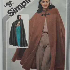 May include: Simplicity sewing pattern number 5199 for a brown hooded cape with a toggle closure. The pattern is for sizes 14-16 and costs $2.50. The text "Tops, skirt & pants not included. Corsages, jupe & pantalon non compris" is printed at the bottom of the pattern.