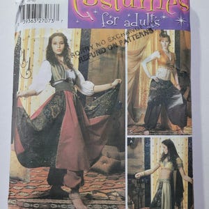 May include: A Simplicity sewing pattern for adult costumes. The pattern features illustrations of three different costume designs, including a long skirt, harem pants, and a crop top. The pattern includes the text "Costumes for adults".
