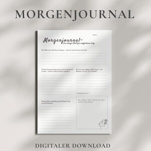 May include: A white journal page with the German text "MORGENJOURNAL" at the top. The journal page has prompts for reflection, with the words "DIGITALER DOWNLOAD" at the bottom. The journal is designed for a calm start to the day.
