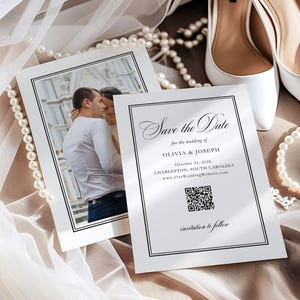 May include: Two white wedding invitations with black borders and text that reads "Save the Date" for Olivia & Joseph, with a photo of a couple. White high heels and a pearl necklace are in the background.
