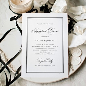 May include: A white invitation card with black text, announcing a rehearsal dinner for Olivia and Joseph. The card is on a marble-patterned plate, with a candle and black ribbon in the background. The text includes the date, time, and location.