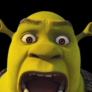 May include: Close-up of Shrek's face, a green ogre with large brown eyes and a wide open mouth. His ears are visible, and he has a surprised expression. The background is solid black.