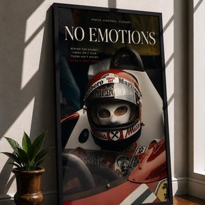 May include: Framed print featuring a vintage race car and driver. The image displays a red and white race car with a driver wearing a helmet. The text "NO EMOTIONS" is at the top, with additional text below. A potted plant sits to the left.