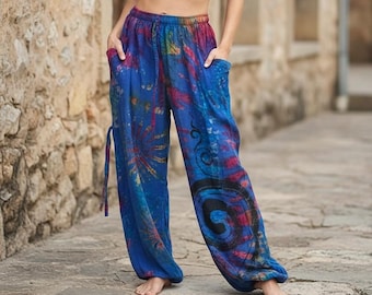 May include: Blue, tie-dye patterned pants with a relaxed fit. The pants feature a drawstring waist, pockets, and colorful abstract designs in red, yellow, and black. The fabric appears lightweight and comfortable.