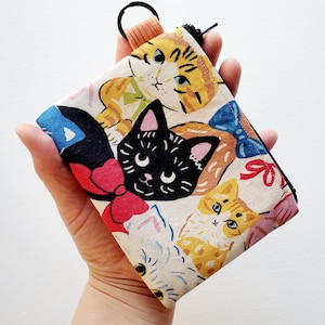 Small wallet with a key ring - 5" wide X 4" long, a zipper pouch with 1 inner pocket, fancy cat print