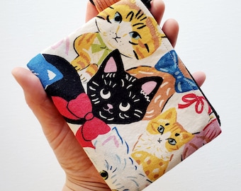 Small wallet with a key ring - 5" wide X 4" long, a zipper pouch with 1 inner pocket, fancy cat print