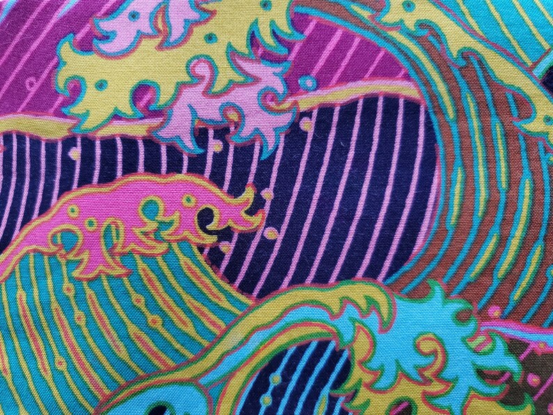 May include: Abstract fabric with a colourful wave pattern in shades of pink, yellow, blue, green, and brown. The fabric has a textured surface and a striped background.