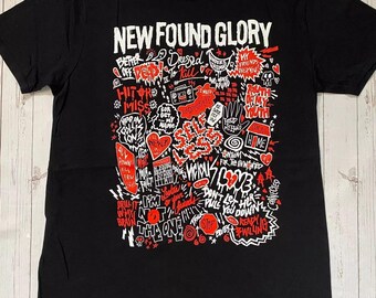 May include: Black t-shirt with the band name "NEW FOUND GLORY" in white block letters at the top. The shirt features a red and white graphic design with various phrases and images.