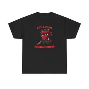 May include: Black t-shirt featuring a cartoon cat ninja with a red headband and mask, holding a sword. The text "CAT-A-CHAN" and "JUNGLE FIGHTER" are printed in red above and below the cat illustration.