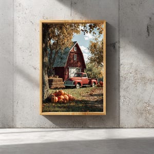 Könnte beinhalten: Ein gerahmter Druck mit einer ländlichen Herbstszene. Ein roter Pickup-Truck steht vor einer roten Scheune. Kürbisse und Heuballen befinden sich im Vordergrund. Der Himmel ist blau mit Wolken.