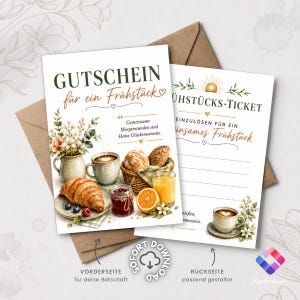 May include: Two rectangular breakfast voucher cards with kraft paper envelopes. The front features the text GUTSCHEIN für ein Frühstück, a bouquet, a croissant, coffee, jam, and orange juice. The back shows FRÜHSTÜCKS-TICKET with lines for text.