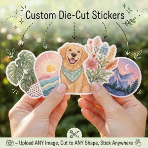 May include: A collection of custom die-cut stickers featuring various designs, including a golden retriever, floral arrangements, and a mountain landscape. The stickers are held in hands against a blurred green background. Text on the image reads: "Custom Die-Cut Stickers."
