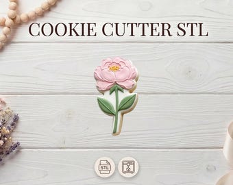 May include: A flower-shaped cookie cutter with a pink peony design. The cookie cutter is on a white wooden surface, with the text "COOKIE CUTTER STL" above it. The image also includes decorative elements like wooden beads, dried flowers, and a ribbon.