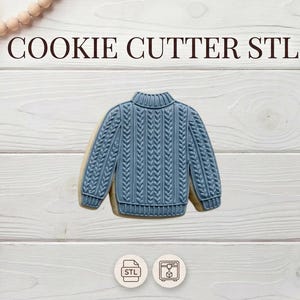 May include: A blue sweater-shaped cookie cutter with a cable knit design. The words "COOKIE CUTTER STL" are at the top. The cookie cutter is on a white wooden surface, with decorative elements in the background.