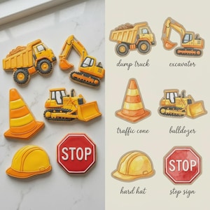 May include: A collection of construction-themed cookies. The cookies include a dump truck, excavator, traffic cone, bulldozer, hard hat, and stop sign. The cookies are yellow, orange, and red with black details. The text "dump truck", "excavator", "traffic cone", "bulldozer", "hard hat", and "stop sign" are also visible.
