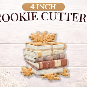 May include: Cookie cutters in the shape of a stack of books and maple leaves. The cookie cutters are 4 inches in size. The image shows the cookie cutters on a white wooden background. The text "4 INCH COOKIE CUTTERS" is at the top.