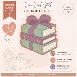 May include: A cookie cutter in the shape of a stack of books with a bow. The books are green and purple with gold accents. The text on the image says "Bow Book Stack Cookie Cutter", "Custom Cookie Cutter", and "cozy & cute!"