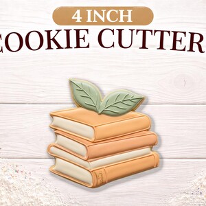 May include: A stack of four book-shaped cookie cutters, each approximately 4 inches in size. The cookies are light orange with white pages and green leaf accents. The text "4 INCH COOKIE CUTTERS" is displayed above.