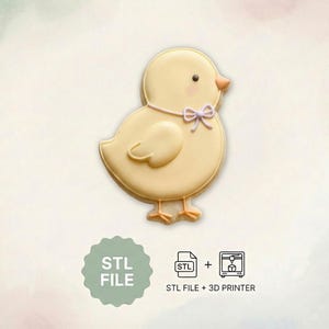 May include: A yellow chick-shaped cookie with a light purple bow tie. The cookie has a small orange beak and a dark dot for an eye. The image also includes the text "STL FILE" and an icon indicating compatibility with a 3D printer.