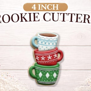 May include: Three stacked 4-inch cookie cutters shaped like mugs. The top mug is light blue with white details, the middle is red with white stars, and the bottom is green with white diamonds. The words "4 INCH COOKIE CUTTERS" are above the mugs.