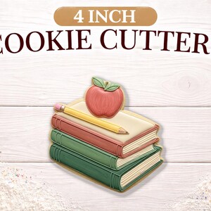 May include: 4 inch cookie cutters in the shape of a stack of books, an apple, and a pencil. The apple is red with green leaves. The pencil is yellow with a pink eraser. The books are red, cream, and green.