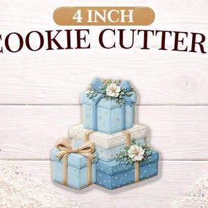 May include: 4 inch cookie cutters in the shape of stacked gift boxes. The boxes are light blue with gold ribbon and floral accents. The background is a white wood grain.