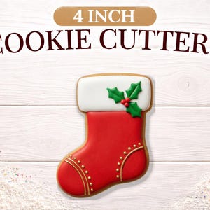 May include: A 4 inch cookie cutter shaped like a Christmas stocking. The stocking is decorated with red icing, a white cuff, and green holly leaves with red berries. The text 4 INCH COOKIE CUTTERS is displayed above the stocking shape.